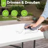 A person is cleaning a white folding table outdoors with a spray bottle and cloth. Produktbild-Vorschau