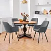 A dining set with a round wooden table and four upholstered chairs in a modern kitchen setting. Produktbild-Vorschau
