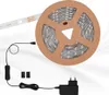 A roll of LED strip lights with its power adapter and switch. Produktbild-Vorschau