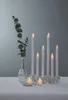 A still life arrangement of LED candles and a vase with eucalyptus. Podgląd zdjęcia produktu