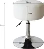 A white adjustable stool with silver base and height adjustment lever. Anteprima dell’immagine prodotto