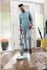A man is cleaning a tiled floor in an entryway with a BISSELL CrossWave HydroSteam Pet Select cleaner. Voir les images du produit