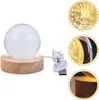 A crystal ball lamp with a wooden base and USB cable, shown with close-up marketing images of its textured surface and base. Náhled obrázku produktu