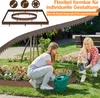 Two women gardening in a backyard, one watering plants with a green watering can, the other holding a potted plant. A brown garden border is visible around a flower bed. Produktbild-Vorschau