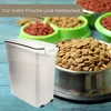 A white pet food storage container is shown in the foreground, with bowls of dog food in the background. Produktbild-Vorschau