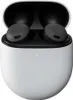A pair of black wireless earbuds in a white charging case. Produktbild-Vorschau