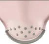 A close-up view of the bottom part of a pink plastic stool with gray rubberized feet. Voir les images du produit
