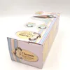 A close-up of a product box, showing its side and top. The box has colorful stripes and decorative images. Podgląd zdjęcia produktu