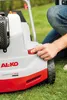 A person's hand is shown adjusting a red knob on a lawnmower. Náhľad obrázku produktu