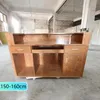 A wooden reception desk in a warehouse or workshop setting. Produktbild-Vorschau
