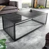 A modern living room setting with a couch and a coffee table. Produktbild-Vorschau