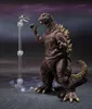 A Godzilla action figure is posed with a small airplane on a stand. Náhled obrázku produktu