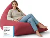 A woman is sitting on a red beanbag chair. Voir les images du produit