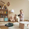 A child playing with a toy tank in a nursery or playroom. Anteprima dell’immagine prodotto