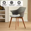 A gray chair with a patterned cushion and wooden legs, placed in a room with a white shelf unit. Produktbild-Vorschau