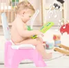 A baby sitting on a pink potty chair and playing with a colorful toy. Produktbild-Vorschau