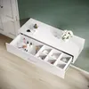 A white wall-mounted vanity table with an open drawer displaying makeup and accessories, set against a green wall and a light wood floor. Anteprima dell’immagine prodotto