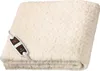 A folded cream-colored heated blanket with a black and white controller attached. Produktbild-Vorschau