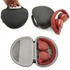 A collage of images showing a black headphone storage case, a black headphone storage case with red accents and red headphones partially out, and an open black headphone storage case with red headphones inside. Produktbild-Vorschau