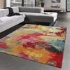 A colorful abstract rug is placed in a modern living room in front of a gray sectional sofa. Podgląd zdjęcia produktu