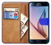 A book-style phone case with a Samsung Galaxy S6 phone inside, along with cards and euro banknotes. Náhled obrázku produktu