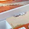 A close-up view of a Satechi USB-C hub attached to the side of an iMac, with a Micro SD card and two USB drives inserted. Produktbild-Vorschau