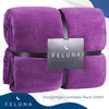 A folded purple blanket with a tag attached. Produktbild-Vorschau