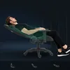 A man is reclining in a gaming chair, demonstrating its adjustable features. The background is dark and abstract, with subtle vertical lines. Below the chair, there are three icons illustrating different seating positions. Produktbild-Vorschau