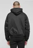 A man wearing a black hooded jacket and black jeans, viewed from the back. Produktbild-Vorschau