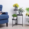 A blue armchair and a black metal plant stand with several potted plants are arranged in a room with a white wall. Náhľad obrázku produktu