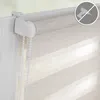 Close-up of a roller blind mechanism and fabric attached to a window frame. Produktbild-Vorschau