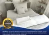 A neatly made bed with pillows and a long bolster pillow, suggesting comfort and relaxation. Produktbild-Vorschau