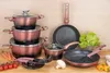 A collection of cookware and kitchen utensils arranged on a wooden surface. Náhľad obrázku produktu