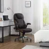 An office chair is placed next to a desk and a bed in a room. Produktbild-Vorschau