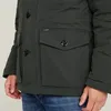 Close-up of a man wearing a dark green jacket and blue jeans. Produktbild-Vorschau
