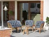 Outdoor patio furniture set with cushions and a small table, placed on a patio in front of a house. Produktbild-Vorschau