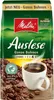 A bag of Melitta Auslese whole bean coffee with a steaming cup of coffee and coffee beans. Produktbild-Vorschau