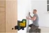 A man is using a laser level to mark a wall. Produktbild-Vorschau
