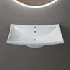 A white ceramic sink is mounted on a gray wall, with a lit mirror above it. Produktbild-Vorschau