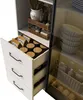 A close-up view of a white cabinet with drawers and shelves, showcasing kitchen items. Voir les images du produit