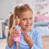 A young girl is holding a doll in her arms, smiling at the camera. The background appears to be a child's bedroom with soft furnishings. Náhľad obrázku produktu