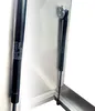 Close-up of gas springs attached to a metal hatch or cover. Produktbild-Vorschau