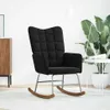 A black rocking chair in a well-lit room with a plant and a side table. Náhľad obrázku produktu