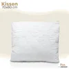A white quilted pillow is shown against a light beige and white background. Produktbild-Vorschau