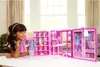 A young girl is playing with a Barbie Dream Wardrobe playset. Produktbild-Vorschau