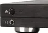 A close-up view of the front panel of a black electronic device, showing a power button and a headphone jack. Produktbild-Vorschau