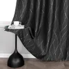 A black curtain with a silver wavy line pattern is draped over a small black side table. A white teacup and saucer sit on a book on the table. Produktbild-Vorschau