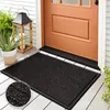 A doormat placed on a wooden porch in front of an orange door. Podgląd zdjęcia produktu