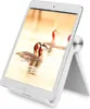 A white tablet stand holding a tablet with a picture of birds on the screen. Náhľad obrázku produktu