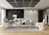 A modern living room scene with a sofa, armchairs, coffee table, and decorative items. Produktbild-Vorschau